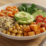 Vibrant Mediterranean chickpea and quinoa power bowl with fresh vegetables in a white bowl on a wooden table