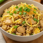 Bowl of Chinese fried rice with chicken and scallions