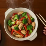 Healthy Chicken Stir-Fry with Velveted Chicken - Restaurant Quality in 30 Min Chicken Stir-Fry: A finished healthy chicken stir-fry with velveted chicken, served in a ceramic bowl with steam rising, on a wooden table.