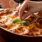 Homemade Classic Beef Lasagna (3 Layer Secret to Perfection) A perfectly baked homemade classic beef lasagna in a ceramic dish with bubbly cheese, fresh basil, and steam rising on a dark wood table.