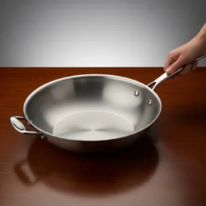 Spacious stainless steel skillet or carbon steel wok with wide cooking surface and helper handle