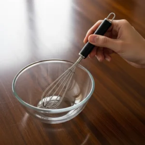Small whisk and glass mixing bowl for stirring Greek yogurt protein box recipe